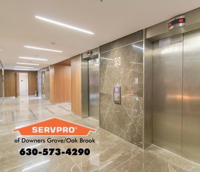 Silver elevator doors in an office hallway.